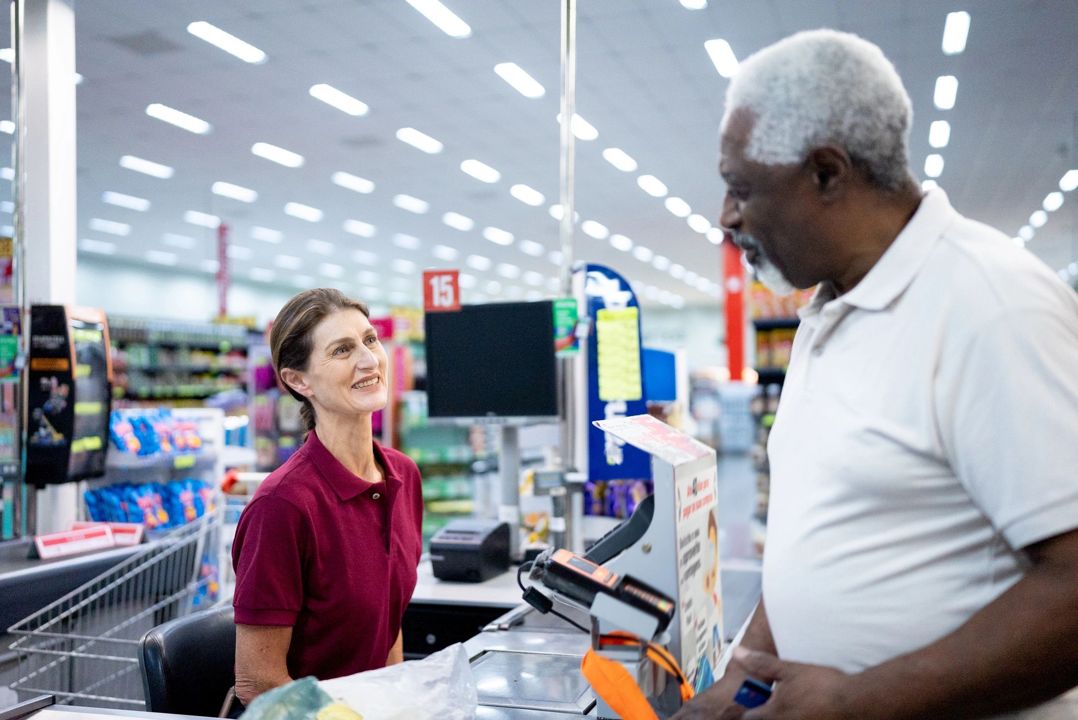 Senior man at supermarket checkout
