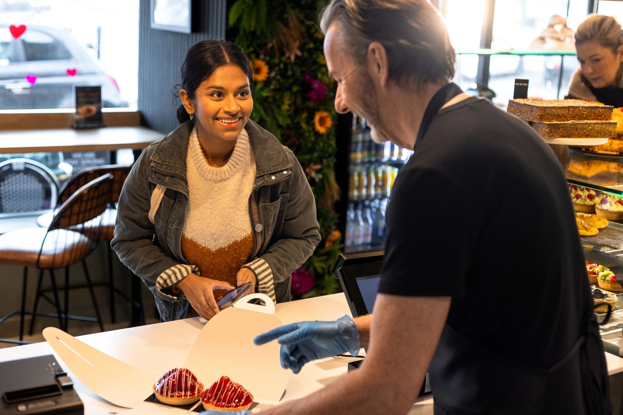 Customer receiving packaged items at a service counter